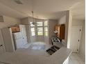 Bright kitchen featuring white appliances, light countertops, and a bay window overlooking the front yard at 1118 Delaware Ave, St Cloud, FL 34769