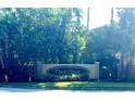 Elegant Oasis Cove community entrance sign nestled amidst lush tropical foliage and landscaping at 14320 Desert Haven St # 3906, Windermere, FL 34786