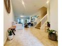 Bright living room with tiled floors, staircase, and a seamless flow into the dining area at 1509 Portofino Meadows Blvd, Orlando, FL 32824