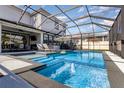 Inviting screened-in pool with a fountain feature and lounge chairs at 16694 Olive Hill Dr, Winter Garden, FL 34787