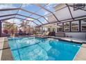 Inviting screened-in pool with a fountain feature and lounge chairs at 16694 Olive Hill Dr, Winter Garden, FL 34787