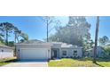 Charming single-story home featuring a two-car garage and well-maintained landscaping at 2033 10Th Ave, Deland, FL 32724