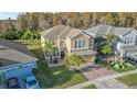 This aerial shot captures the home's location, manicured lawn, landscaping, and proximity to neighboring houses at 2250 Windcrest Lake Cir, Orlando, FL 32824