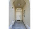 Covered front entryway with tiled floor and a white front door at 231 Old Mill Cir, Kissimmee, FL 34746