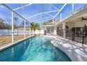 Inviting screened-in pool with clear blue water, perfect for relaxation and outdoor entertaining at 248 Breezy Oaks Ct, Davenport, FL 33896