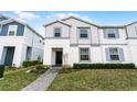 Inviting townhome with a gray brick walkway, well-kept landscaping, and a freshly painted exterior at 281 Jetty Way, Davenport, FL 33897