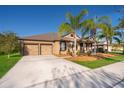 Single-story home boasting a two-car garage, beautiful landscaping, and a well-kept lawn at 2864 Lafayette Trace Dr, St Cloud, FL 34772