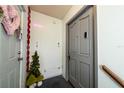 Inviting entryway with decorative accents and modern gray door at 3060 George Mason Ave # 12 D, Winter Park, FL 32792