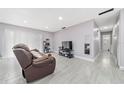 Bright living room featuring tile flooring and a sliding glass door at 3060 George Mason Ave # 12 D, Winter Park, FL 32792
