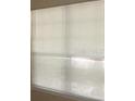 Close up of a window covered with white horizontal blinds at 3712 Castle Pines Ln # 4126, Orlando, FL 32839