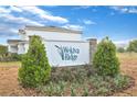 Wekiva Ridge community sign, with landscaping and a partial view of a home in the background at 3741 Deer Ridge Dr, Mount Dora, FL 32757