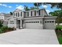 Two-story home featuring a three car garage, gray paint, black shutters and a well maintained lawn at 3741 Deer Ridge Dr, Mount Dora, FL 32757