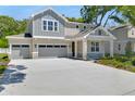 Attractive two-story home with a three-car garage, spacious driveway, and lush landscaping at 3749 Deer Ridge Dr, Mount Dora, FL 32757