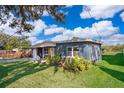 Charming single-story home with a well-maintained lawn, a light-grey exterior, and mature landscaping at 4217 Park Lake St, Orlando, FL 32803