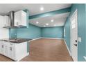 Open living room with light blue walls, modern cabinets, and wood-style flooring at 4217 Park Lake St, Orlando, FL 32803