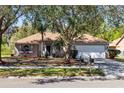 Attractive single-story home featuring a well-kept lawn and mature trees at 4222 Gold Rush Ln, St Cloud, FL 34772