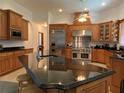 Gourmet kitchen featuring stainless steel appliances, custom cabinetry, and a center island at 4261 Twilight Trl, Kissimmee, FL 34746