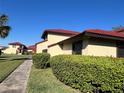Attractive home exterior featuring manicured shrubs and vibrant red tile roof at 433 Hunter Circle Cir, Kissimmee, FL 34758