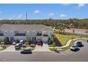 Exterior view of well-maintained townhomes with garages, neat landscaping, and ample parking in a suburban setting at 4544 Teoli Ct, Kissimmee, FL 34746