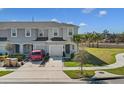 Inviting townhome boasting a private garage, and a manicured front yard showcasing attractive landscaping and curb appeal at 4544 Teoli Ct, Kissimmee, FL 34746