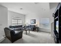 Bright living room features plush carpeting, large windows with blinds, and comfortable seating arrangements at 509 Cadiz Loop, Davenport, FL 33837