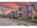 Tan and brick two-story condo complex with parking and well-maintained landscaping at 5530 Chrishire Way # D204, Orlando, FL 32822