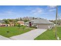 Beautiful single-Gathering home with a lush green lawn, red door and two car garage at 559 Kingfisher Dr, Kissimmee, FL 34759