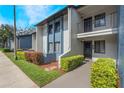Clean condo exterior with blue and white facade, well-maintained walkway, and manicured landscaping at 6 Escondido Cir # 58, Altamonte Springs, FL 32701