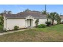Charming single-story home featuring a well-maintained lawn and neutral exterior paint at 734 Olympic Cir # 30, Ocoee, FL 34761