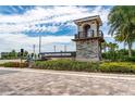Stone entrance and signage for Isles of Lake Nona community with lush landscaping and water feature at 10414 Folly Beach Rd, Orlando, FL 32827