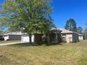 Charming single-story home with a well-maintained lawn and mature tree in a suburban neighborhood at 138 Inconnu Ct, Kissimmee, FL 34759