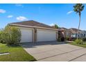 This home boasts a three-car garage with well maintained landscaping, and a spacious driveway at 141 Prestwick Dr, Davenport, FL 33897