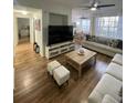 Bright living room featuring hard surface floors, ceiling fan, and large windows at 2558 Robert Trent Jones Dr # 1412, Orlando, FL 32835