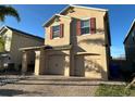Inviting two-story home featuring a two-car garage and brick paved driveway at 2777 Monticello Way, Kissimmee, FL 34741