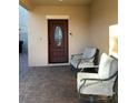 Inviting front porch with seating and a stylish entryway door at 2777 Monticello Way, Kissimmee, FL 34741