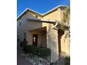 Cozy front porch features dark front door, chair, and lovely landscaping at 2777 Monticello Way, Kissimmee, FL 34741