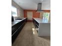 Spacious kitchen featuring modern appliances, a large island, and stone accents at 2812 Tower Rock St, Kissimmee, FL 34758