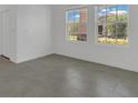 Bright living room with two large windows, white walls, and ceramic tile flooring at 2884 Nottel Dr, St Cloud, FL 34772