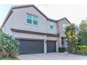 Stylish two-story home with a three-car garage, brick driveway and stone details at 3100 Stonewyck St, Orlando, FL 32824