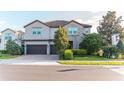 Charming two-story home with a three-car garage and brick-paved driveway at 3100 Stonewyck St, Orlando, FL 32824
