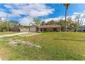 Inviting single-story home with a classic brick facade, lush lawn, and a convenient two-car garage at 3189 Saint James Ave, Deltona, FL 32738