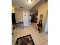 Inviting foyer with tile flooring that flows into the living area, showcasing an open floor plan at 3449 Village Green Ct, St Cloud, FL 34772