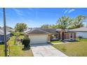 Inviting home with a spacious driveway and landscaping, perfect for curb appeal at 410 Lark Ct, Kissimmee, FL 34759