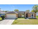 Well-kept home with a garage and front lawn, offering comfort and convenience at 410 Lark Ct, Kissimmee, FL 34759