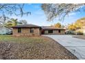 Charming brick single-story home featuring a well-maintained lawn and long driveway at 4172 Stonehenge Rd, Mulberry, FL 33860