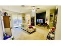 Open-concept living room features sliding glass doors to the backyard patio at 419 Cierra Oaks Cir, Lady Lake, FL 32159