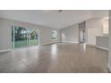 Bright living room showcasing sliding glass doors to the backyard and sleek tile flooring at 421 Britten Dr, Kissimmee, FL 34758