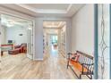 Inviting entryway featuring wood-look tile flooring, tray ceilings, fresh paint, and decorative shelving at 461 Treviso Dr, Poinciana, FL 34759