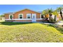 A single-story home featuring a vibrant green lawn and front entrance at 602 N Delmonte Ct, Kissimmee, FL 34758