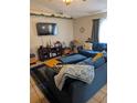 Inviting living room featuring cozy blue sofa and modern decor at 7143 Edgewater Shores Ct, Orlando, FL 32810